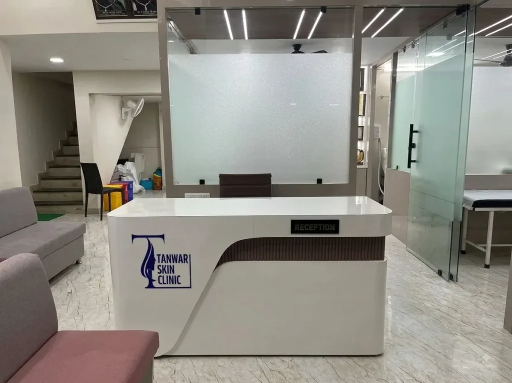 Front reception desk at Tanwar Skin Clinic with prominent brand signage and modern interior design.